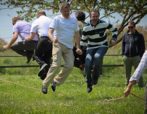 a group of men jumping rope.