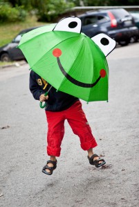 child with a frog umbrella